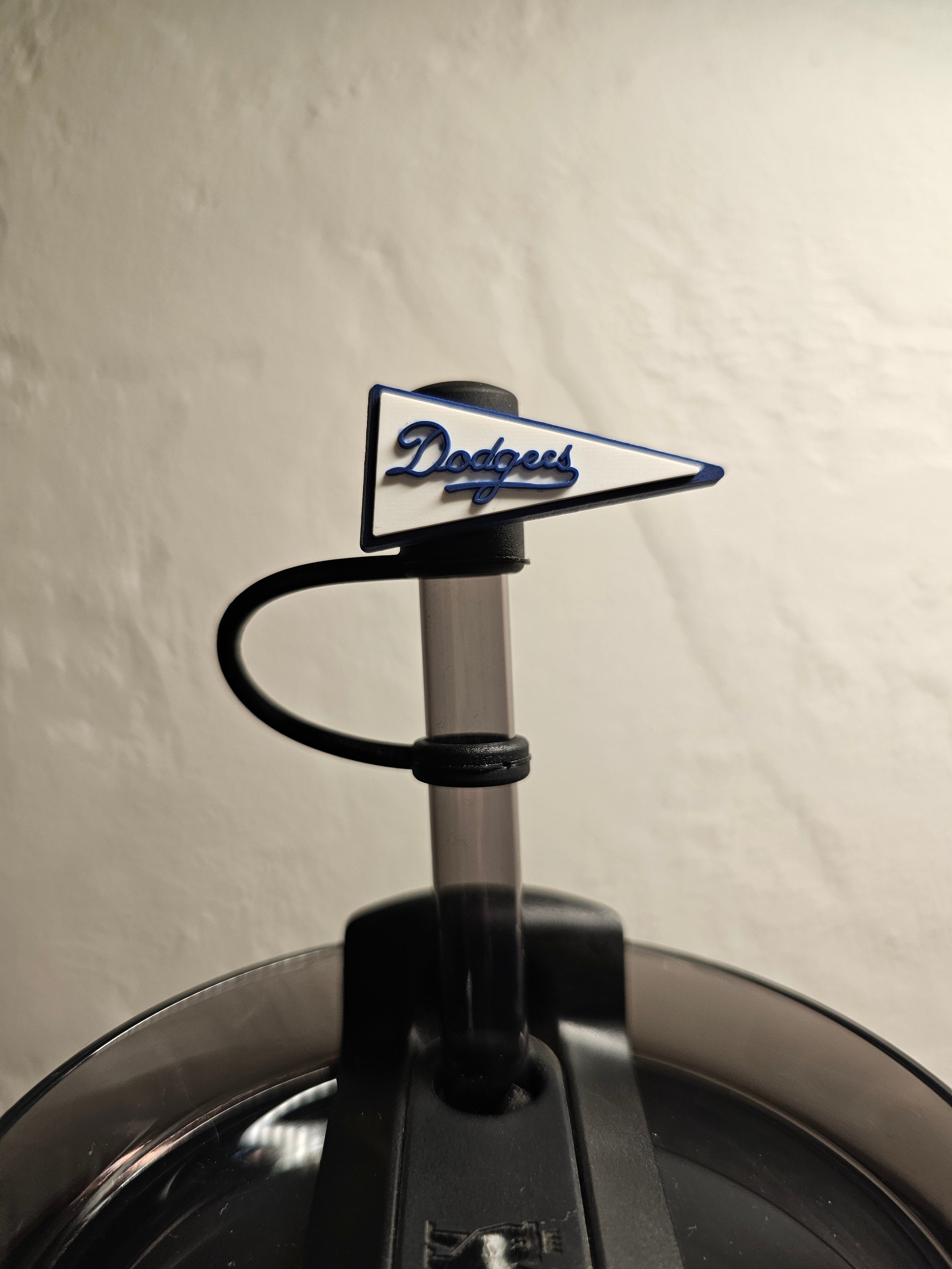 Los Angeles Dodgers bottle opener on a grassy field with trees in the background